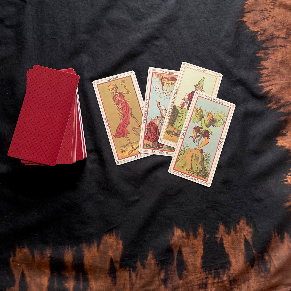 Set of tarot cards on a dark fabric surface