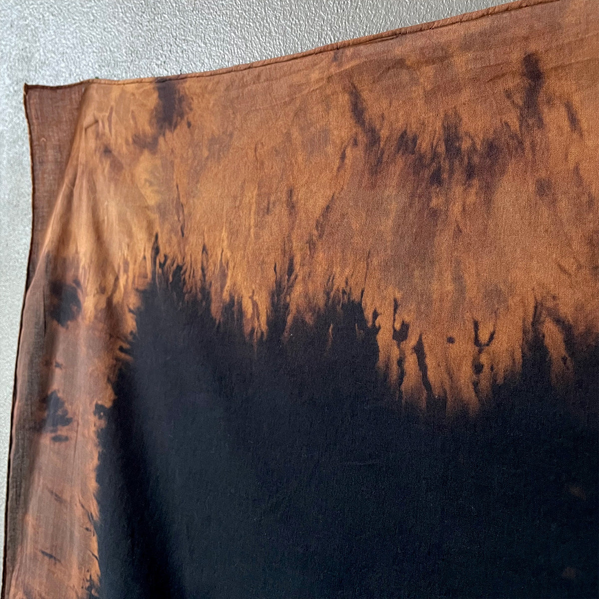 Textile with brown and black gradient on a plain background