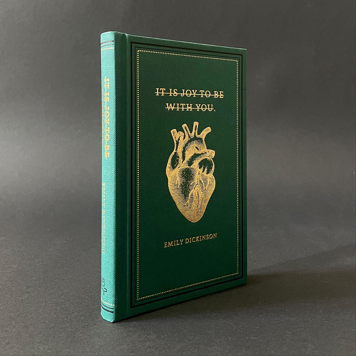 An edition of It Is Joy To Be With You by Emily Dickinson featuring a gold embossed heart on dark green cover.