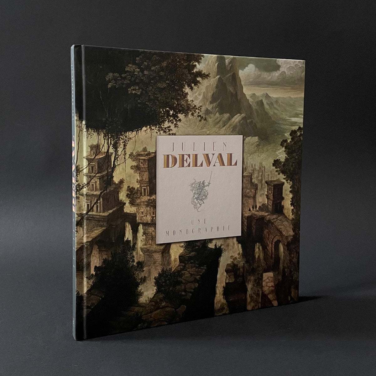 A book entitled "A Monograph" with illustrated cover depicting a fantasy city against a dark background.