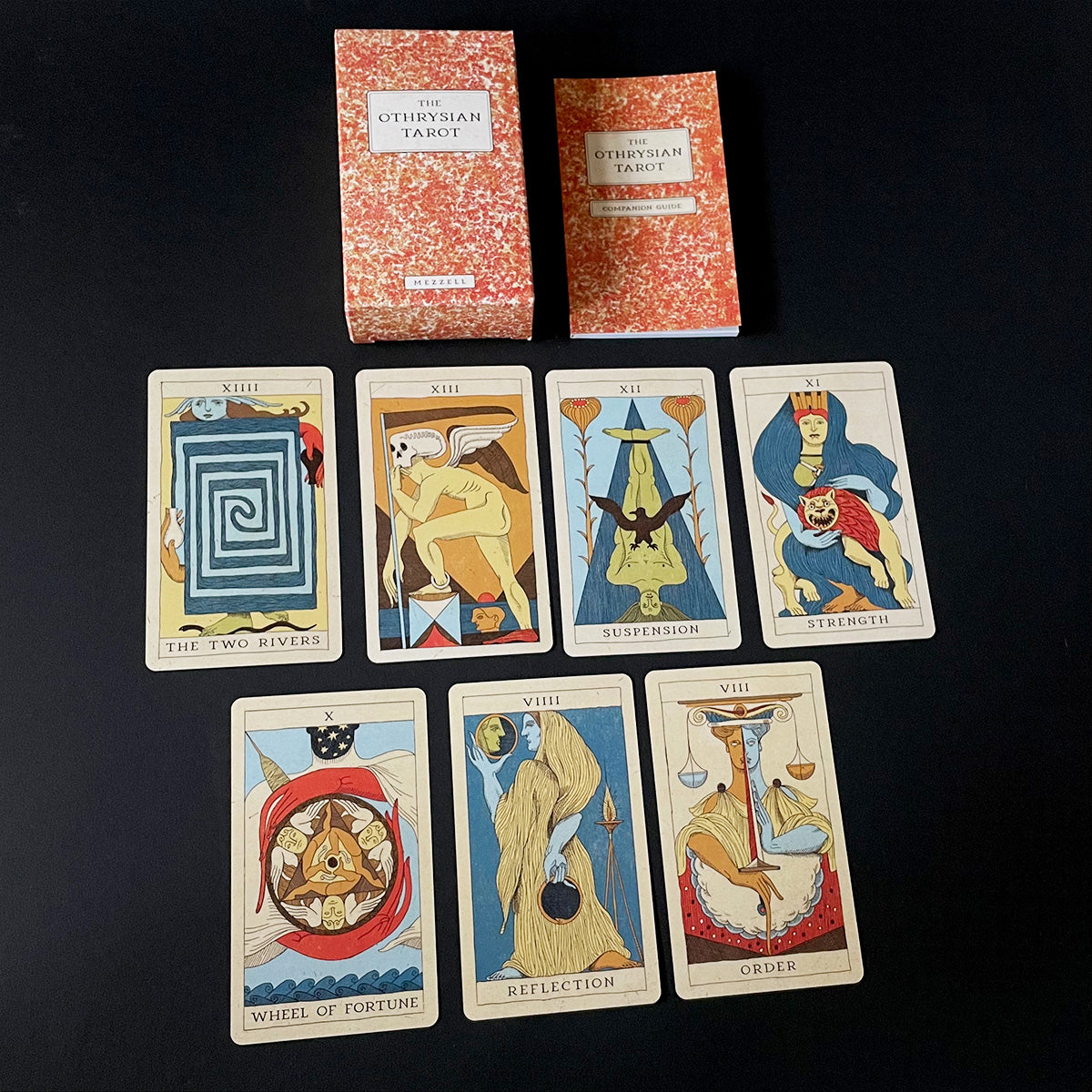 Collection of tarot cards with their packaging on a black background