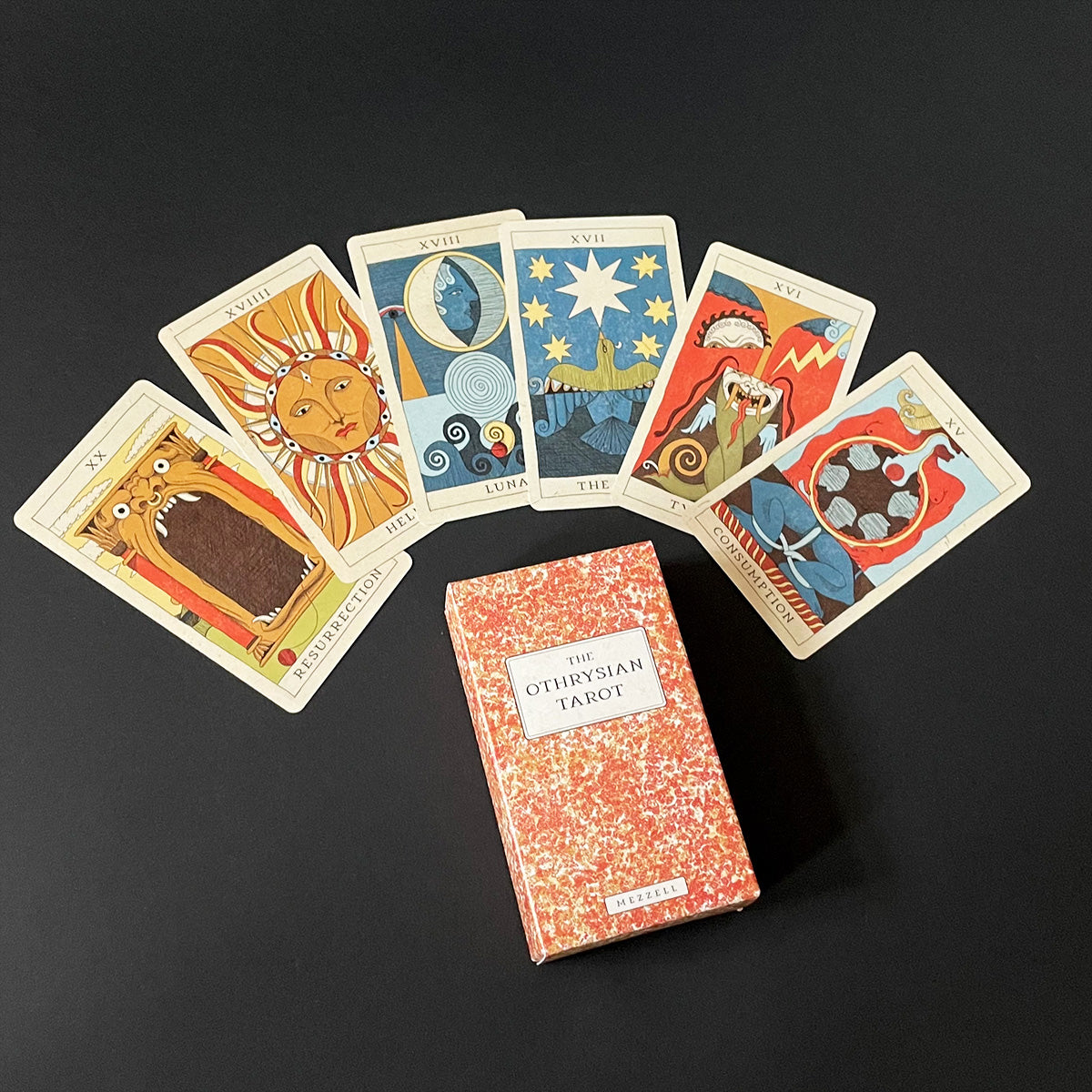Othiysonian Tarot cards with a deck box on a dark background