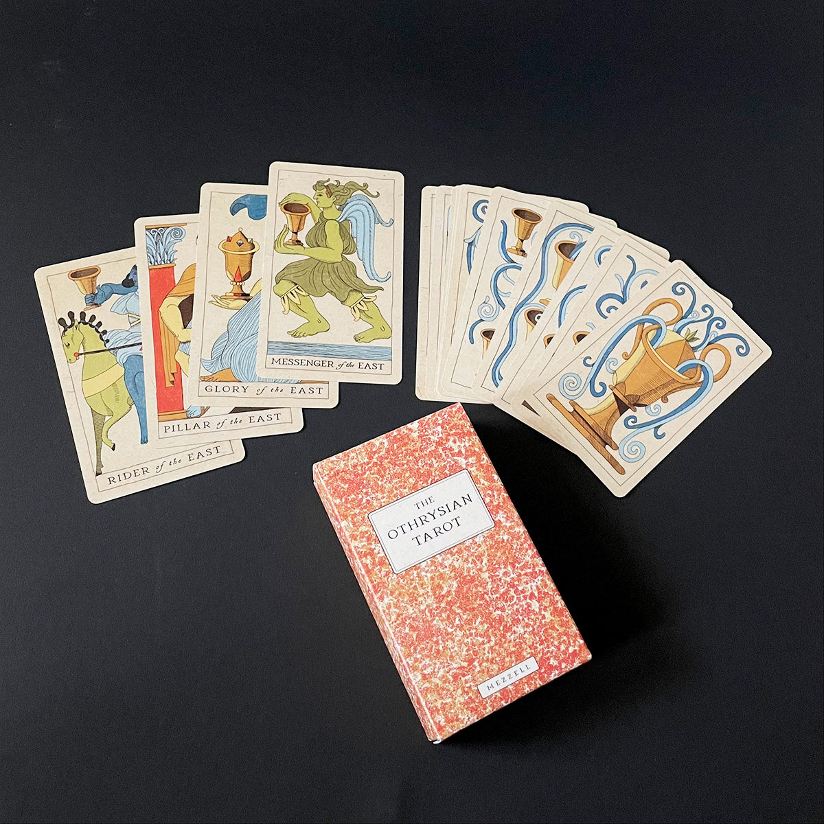 Othryrian Tarot cards with a deck on a black background