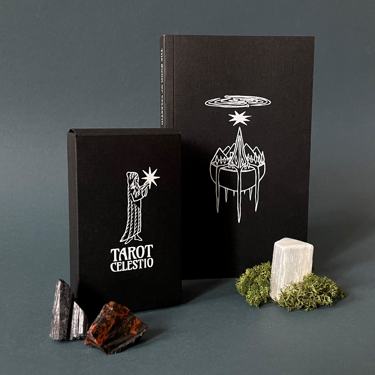A Tarot Celestio deck and The Book of Celestio  The setting is against a dark background with some decorative elements.