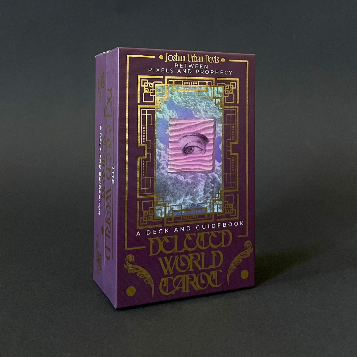 A boxed tarot deck titled 'Deleted World Tarot' with a purple and black design, featuring an image of an eye on the packaging.