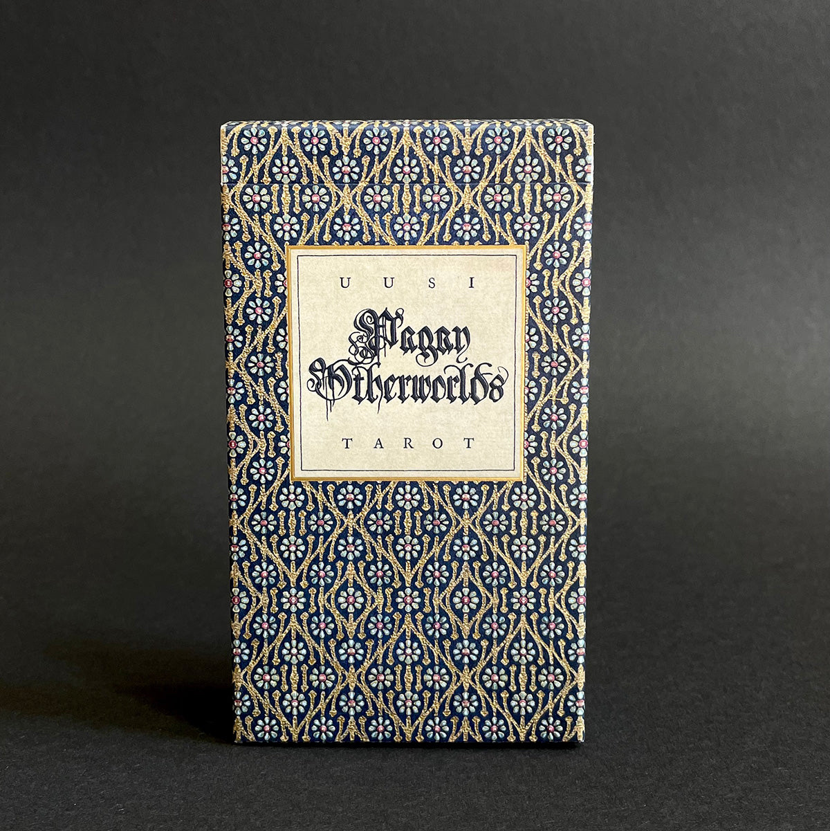 A tarot deck titled 'Pagan Otherworlds' with a decorative blue and white pattern on the packaging.