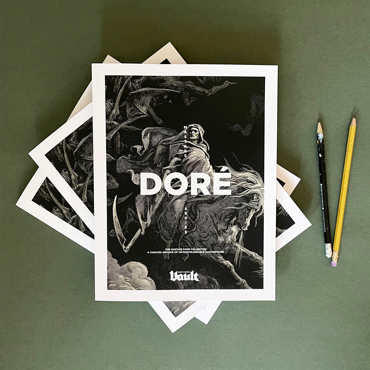 A collection of black and white illustrations by Gustave Doré, with the artist's name printed at the bottom, displayed on a table alongside pencils.