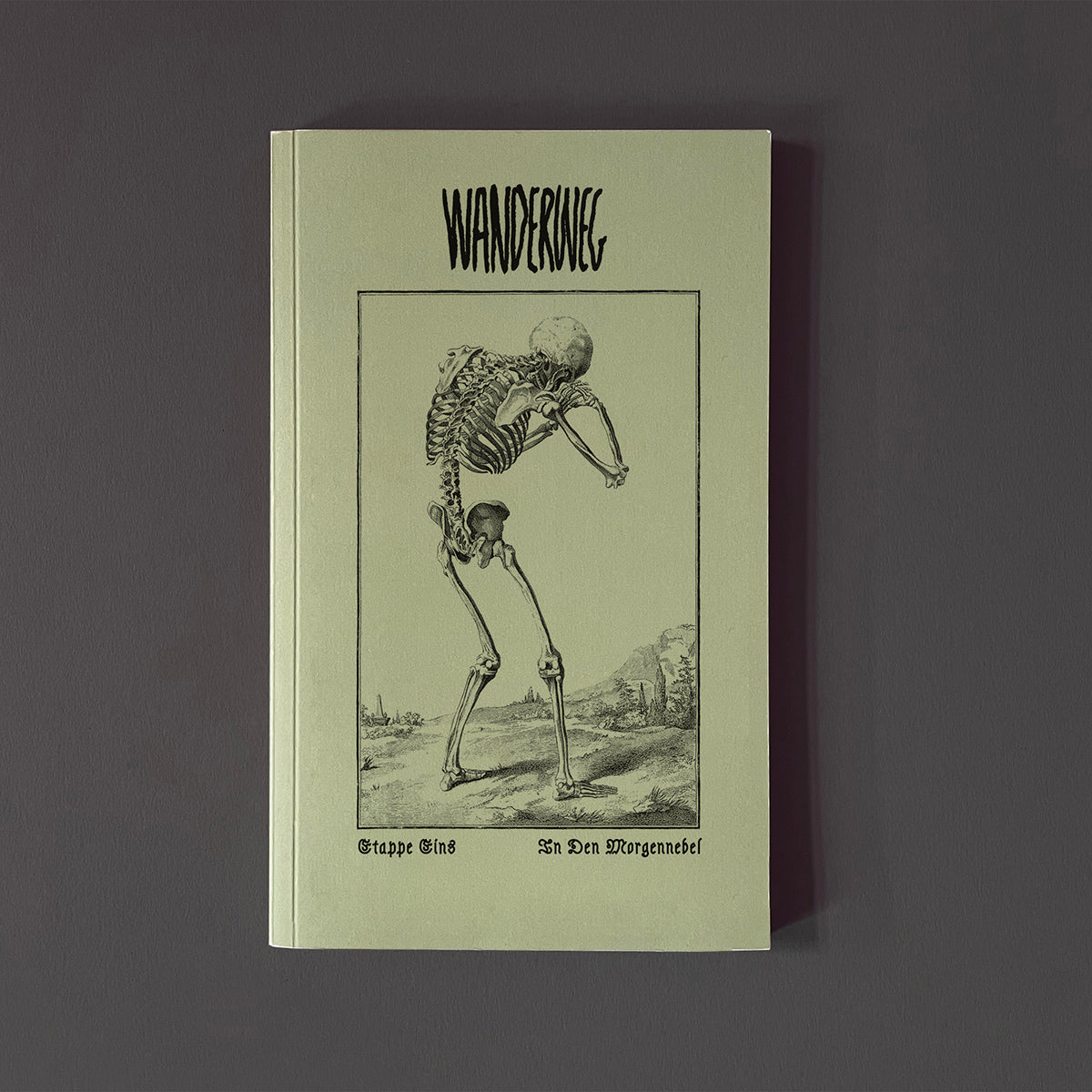 Magazine titled 'Wanderweg' with skeleton illustration and text on a dark background
